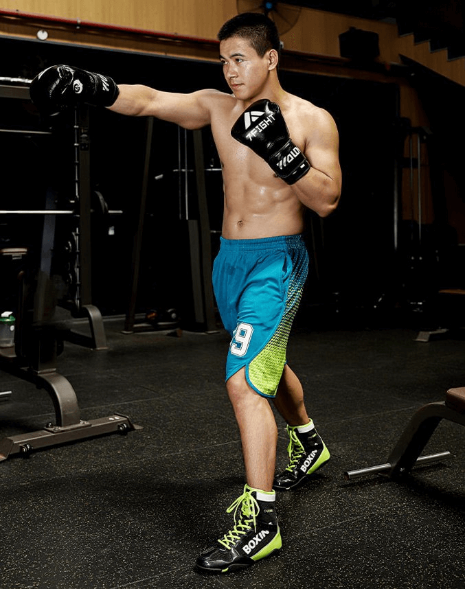 Athlete wearing SF1202 wrestling sneakers in gym, showcasing flexibility and anti-slip design for optimal performance.